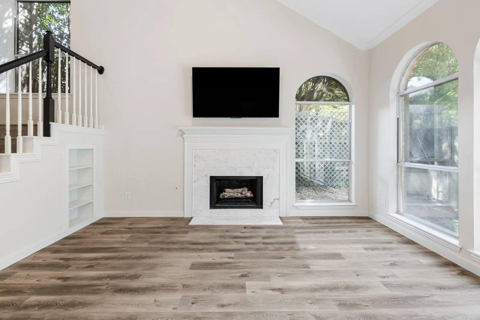 Living room at Azure Ln. in Addison after new flooring, paint, and a refreshed fireplace