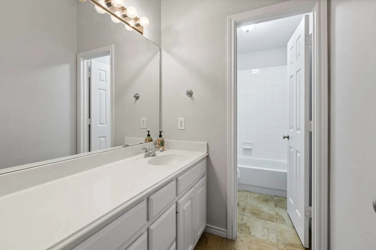Bath vanity with new white counters at Biscayne in Frisco