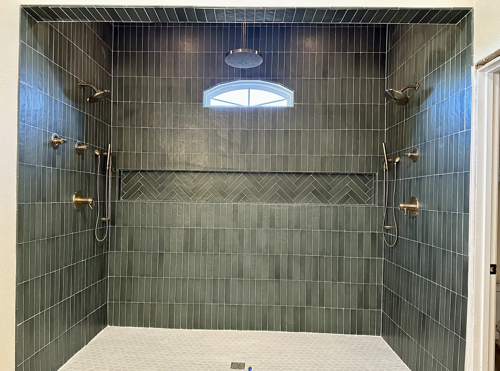 Wet-room style shower with dual rain heads at Lake Breeze Dr. in McKinney
