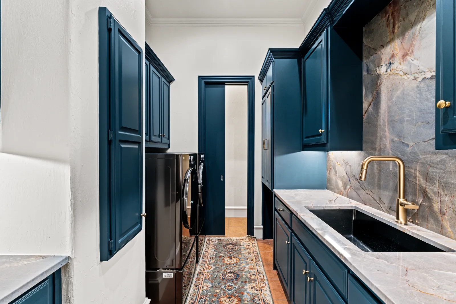 Spa-inspired primary bathroom at Prestwick Ln in Dallas, TX by Renovation Sells Dallas: freestanding tub, marble-look tile, and brass fixtures