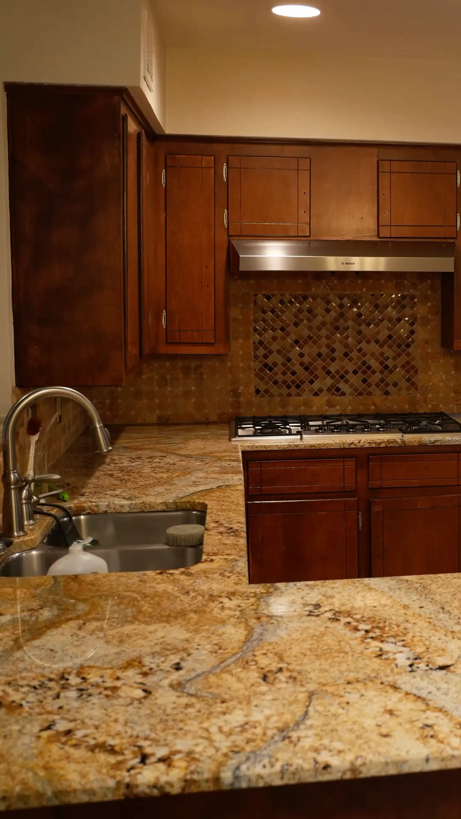 Vancouver Dr. kitchen in Preston Hollow before the remodel: dark cherry cabinets and granite